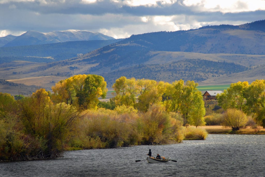 Anglers fly fishing the Madison River near Yellowstone National Park in Cameron Montana in autumn. Fall foliage lines the river banks while the Gravelly Mountains loom high. from Tumbleweed Travel