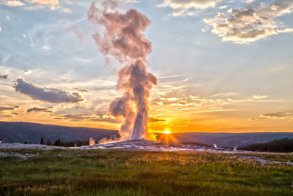 Old Faithful Geyser Eruption in Yellowstone National Park at Sunset Old Faithful Geyser Eruption in Yellowstone National Park at Sunset from Tumbleweed Travel