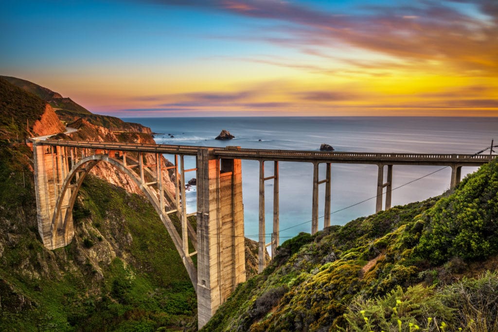 Bixby Bridge (Rocky Creek Bridge) and Pacific Coast Highway at sunset near Big Sur in California, USA. Long exposure. Bixby Bridge Rocky Creek Bridge and Pacific Coast Highway at sunset near Big Sur in California USA. Long exposure. 1 from Tumbleweed Travel