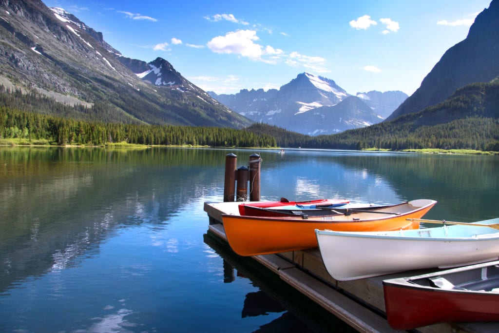Canoes by lake Mc Donald in Glacier national park from Tumbleweed Travel