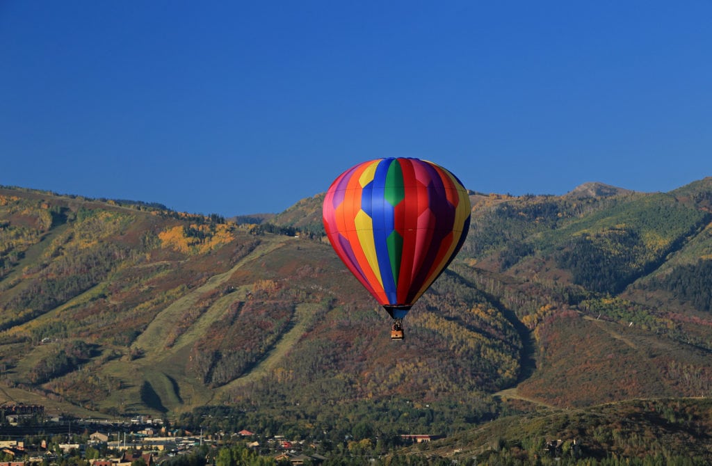Colorful hot air balloon with autumn colors in the mountains above Park City, Utah, USA. Colorful hot air balloon with autumn colors in the mountains above Park City Utah USA. from Tumbleweed Travel