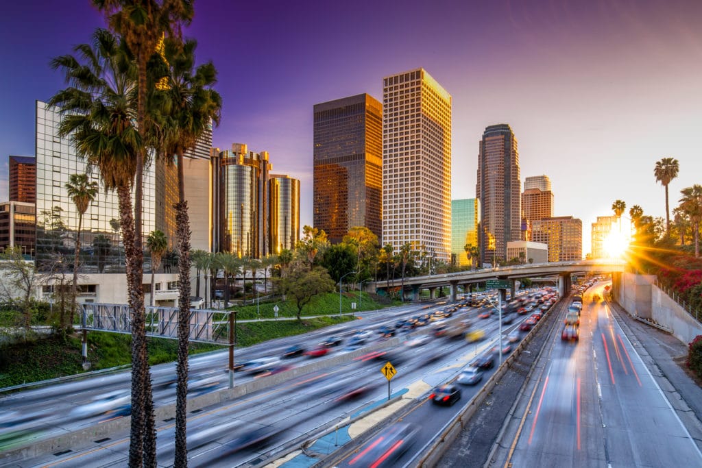 Los Angeles downtown buildings and highway car traffic at sunset Los Angeles downtown buildings and highway car traffic at sunset from Tumbleweed Travel