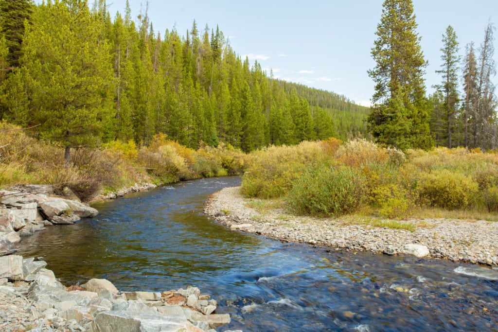 River flowing through mountain landscape in Yellowstone National Park. River flowing through mountain landscape in Yellowstone National Park. from Tumbleweed Travel