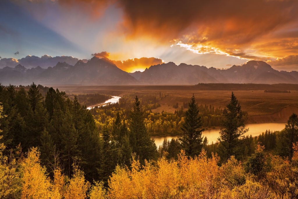 The sun sets behind the Teton Range and Snake River in Grand Teton National Park, Wyoming. The sun sets behind the Teton Range and Snake River in Grand Teton National Park Wyoming. from Tumbleweed Travel