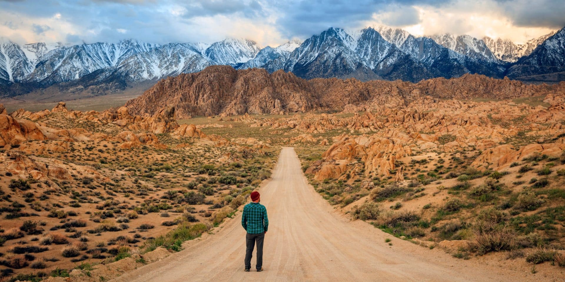 Man standing on a dirt road in the Sierra Nevada Mountains California USA. scaled from Tumbleweed Travel