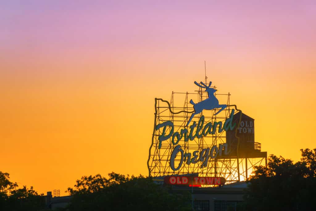 Sunset over the iconic Portland Oregon Old Town sign in downtown Portland Oregon from Tumbleweed Travel