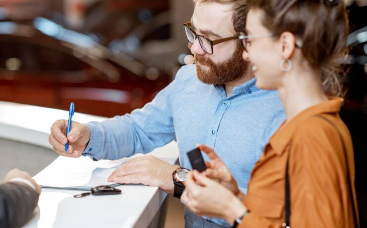 How to Rent an RV Couple standing at a RV rental desk