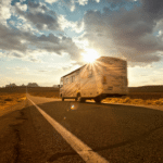 Class A RV driving into the Sunset in the desert of Utah