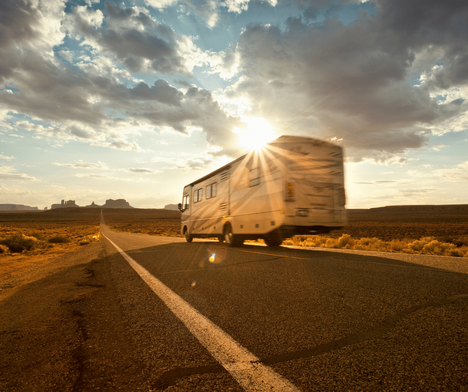 Class A RV driving into the Sunset in the desert of Utah