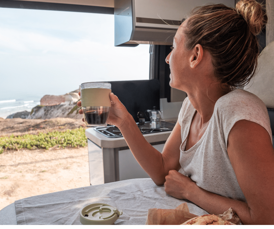 How to Make Coffee While Traveling in an RV Woman enjoying coffee in an RV from Tumbleweed Travel